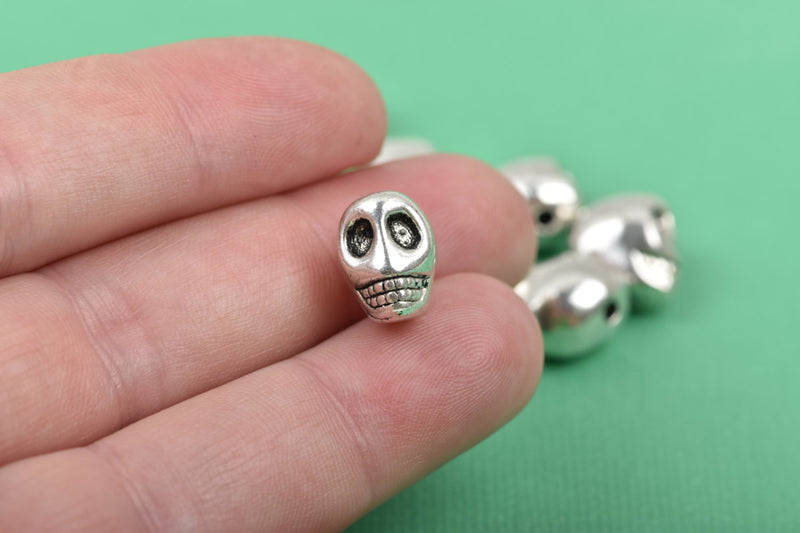 10 Silver Metal SKULL Beads, drilled top to bottom, 12mm, bme0401