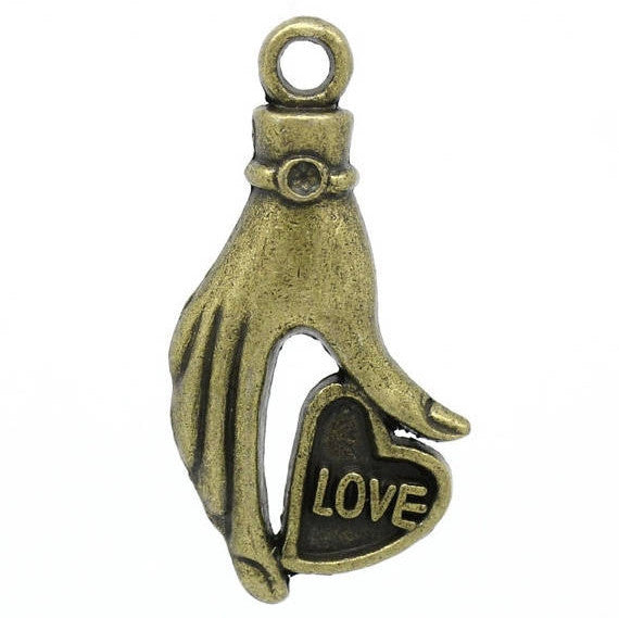10 Antique Bronze Metal Love Heart in Hand Charm Pendants. CHB0184