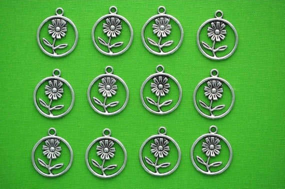 10 Small Antique SILVER Metal FLOWER Circle Charms . 21mm x 18mm chs1083