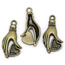 10 Antique Bronze Metal Love Heart in Hand Charm Pendants. CHB0184