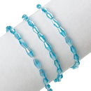22" Strand Crystal Elongated Bicone Beads . AQUAMARINE BLUE AB 8mm x 4mm about 75 beads, bgl0045